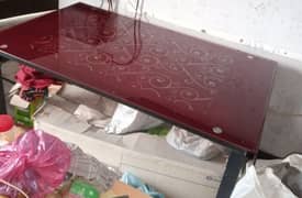 glass top maroon colored dinning table