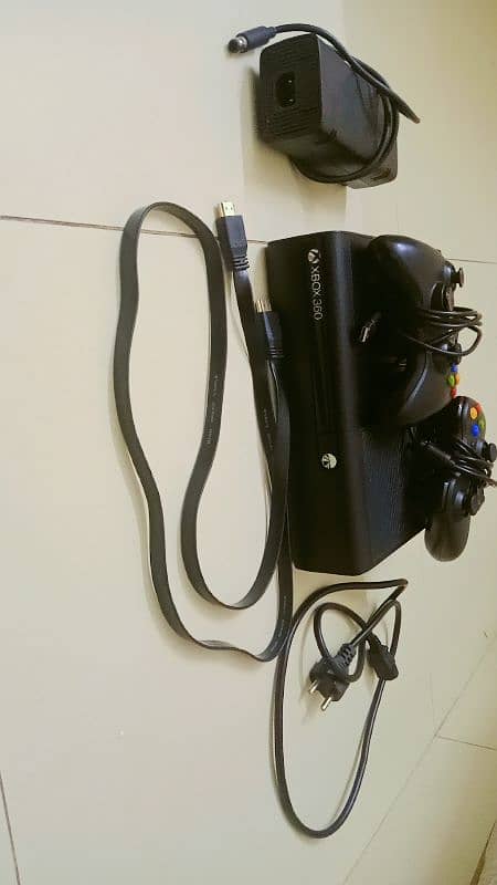 Xbox 360 E with one CD and two controllers 1