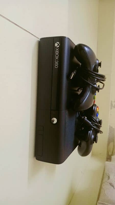 Xbox 360 E with one CD and two controllers 2