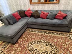 L shaped sofa with a pair of chairs