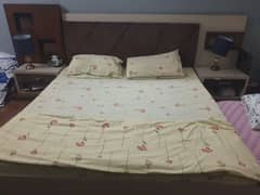wooden bed with 2 side tables and dressing table