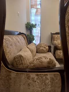 Featuring a rich patterned upholstery in warm tones of beige and brown
