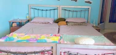 Iron beds and L shaped sofa