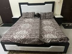 Black and white Queen size bed with side tables