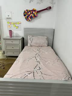 Single bed along foam with side table