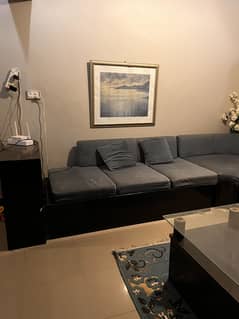 L shaped grey and black sofa with table