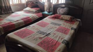 2 single wooden beds with mattress