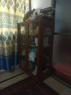"Wooden Glass Almirah with Wheels – Almost New, Urgent Sale!"