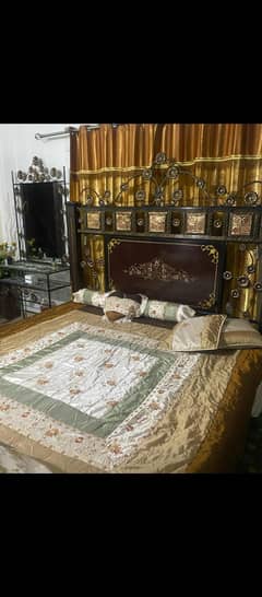 Pure wood and iron bed with dressing table.