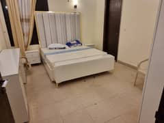 slightly used modern bed with side tables