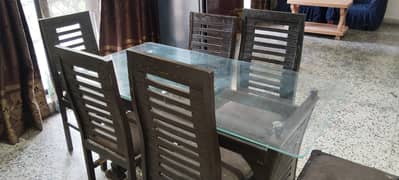 Wooden dining table with 6 chairs for sale .