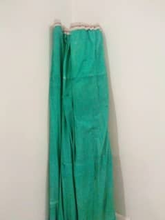green clothes sheet with wooden sticks inside to protect from sunlight