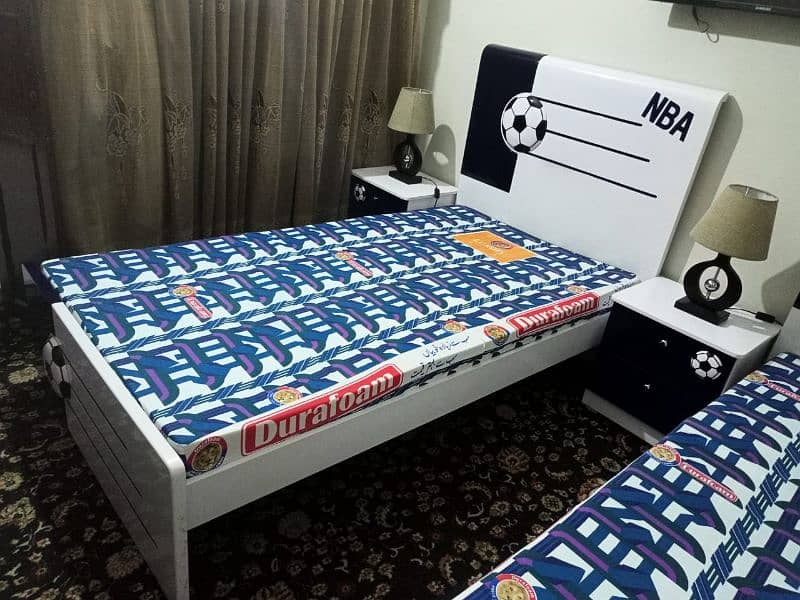 2 single beds with 2 side tables with 2 mattresess and lamps 1