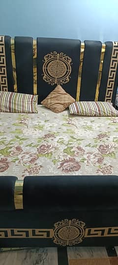 black bed with mattress and one side table