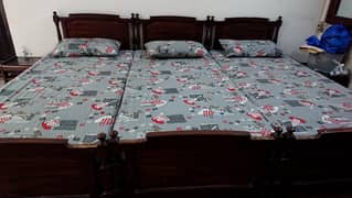 3 Wooden Beds with mattress and sheet covers