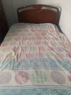 Wooden bed with mattress