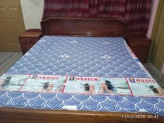 Wooden Bed with 2 side tables and storage boxes.