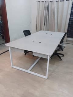 workstation table with two office chairs