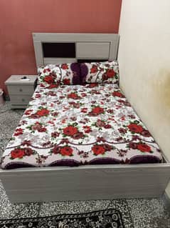 Single bed with mattress and side table