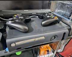 Xbox 360 Console with 5 games and one wired controller .