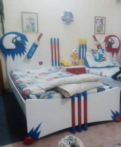 Two single beds with side table and mattress