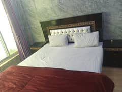 Furnished bed room with site table and mirror table
