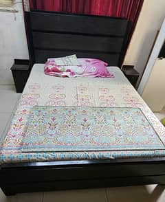 standard size bed with side table