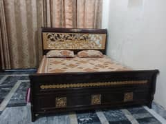 wooden bed with dressing table and mirror