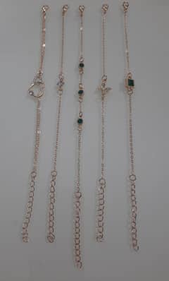 A set of five gold-plated bracelets available for sale