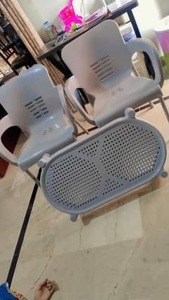 2 Plastic Chairs with a Table