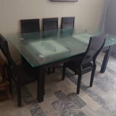 wooden dining table with glass top + 8 wooden chairs