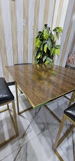 Brown Wood Sheet Table With 4 black leather comfortable seats