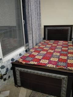 wooden bed with silver coloured contross