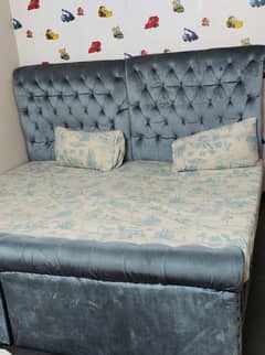 2 cushioned single bed with mattresses and center table