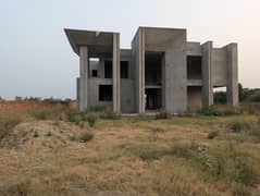 1.25 Kanal House with around 3 Kanal lawn well surrounded by walls.