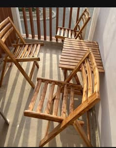 2 wooden chairs and 1 table