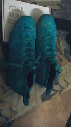 Football cleats blue cyan color
