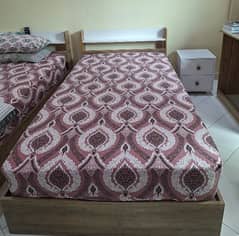 2 single beds without side tables and mattresses