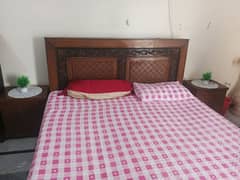 double bed with mattress and side tables