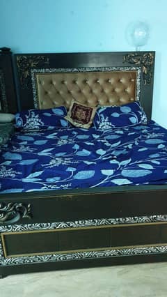 less used bed ,side table and dressing mirror