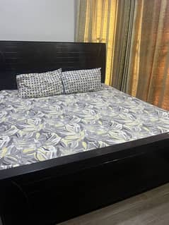 Wooden bed with dracing and mirror