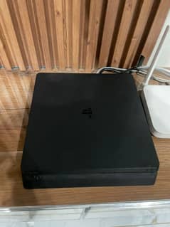 ps4 slim 1tb 2 controllers and a box