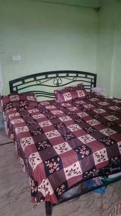 black iron bed with metris