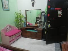 queen size bed with side table and dressing