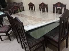 8 wooden chairs with glass dinning table