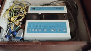 ECG machine with movable storage trolley and patient bed