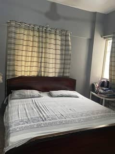 wooden bed with wooden cupboard
