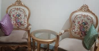 2 wooden chairs with table