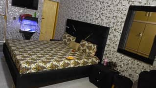 room bed with two chairs and two side tables