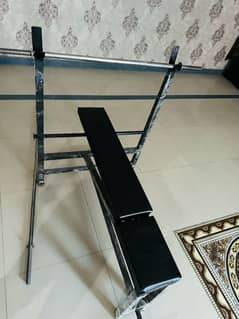 gym bench rods and dumbles